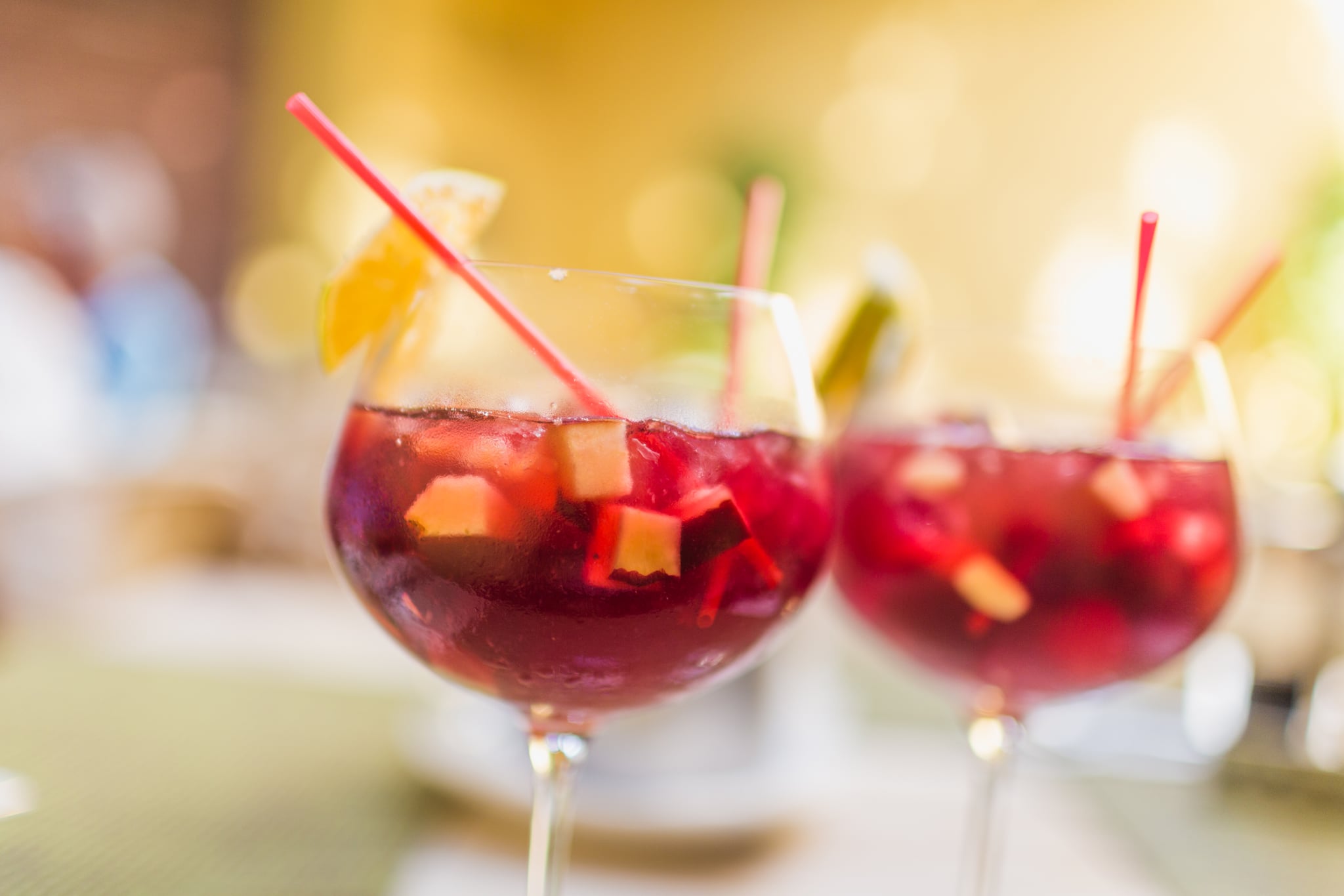 Two refreshing glasses of sangria with fruits, waiting to be savored.