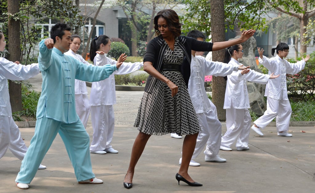 Michelle Obama tried her hand at tai chi with students at a Chengdu school.