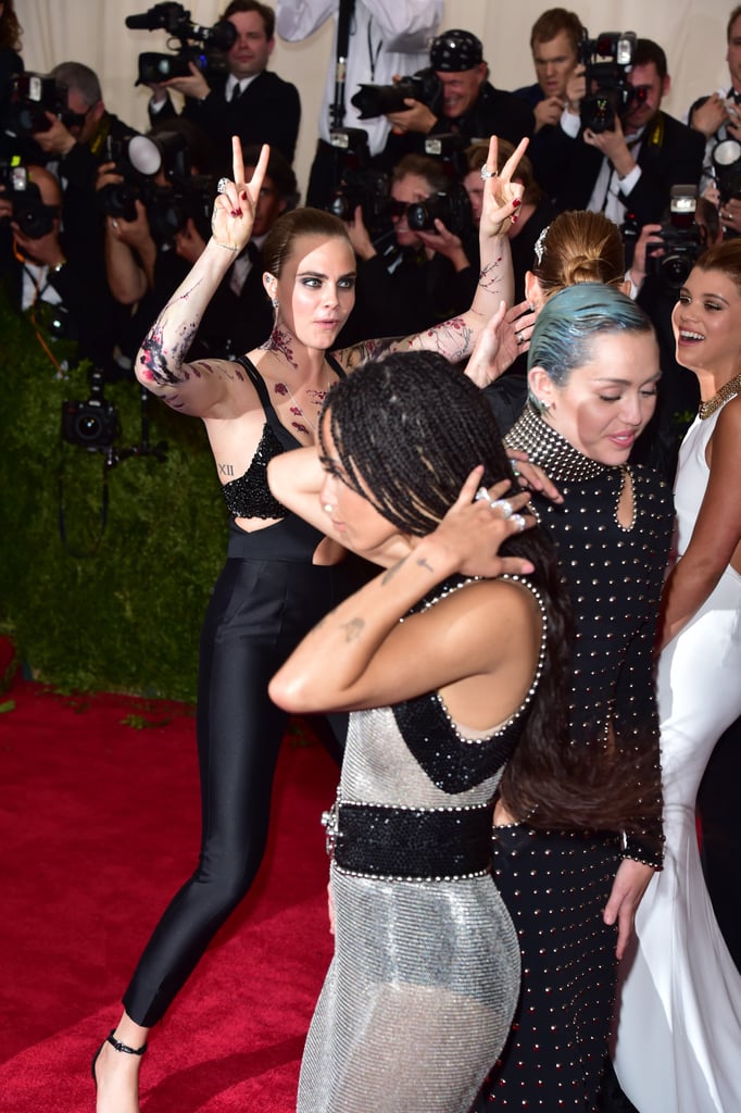 Cara Delevingne threw up the peace sign on the red carpet.