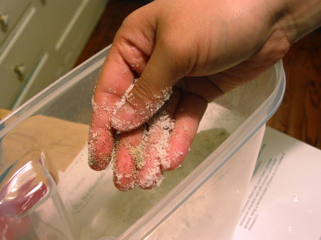 Work seeds into sugar with fingers. 