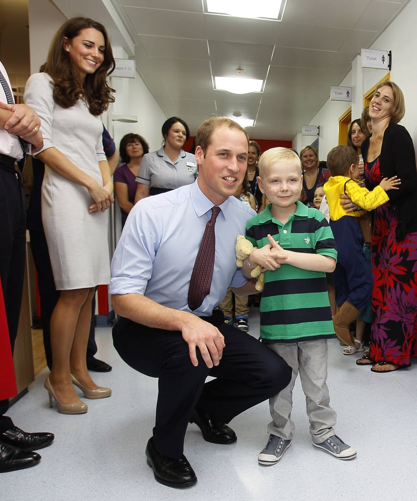 Kate Middleton looked on while Prince William posed with a young boy at London's Royal Marsden Hospital in September 2011.