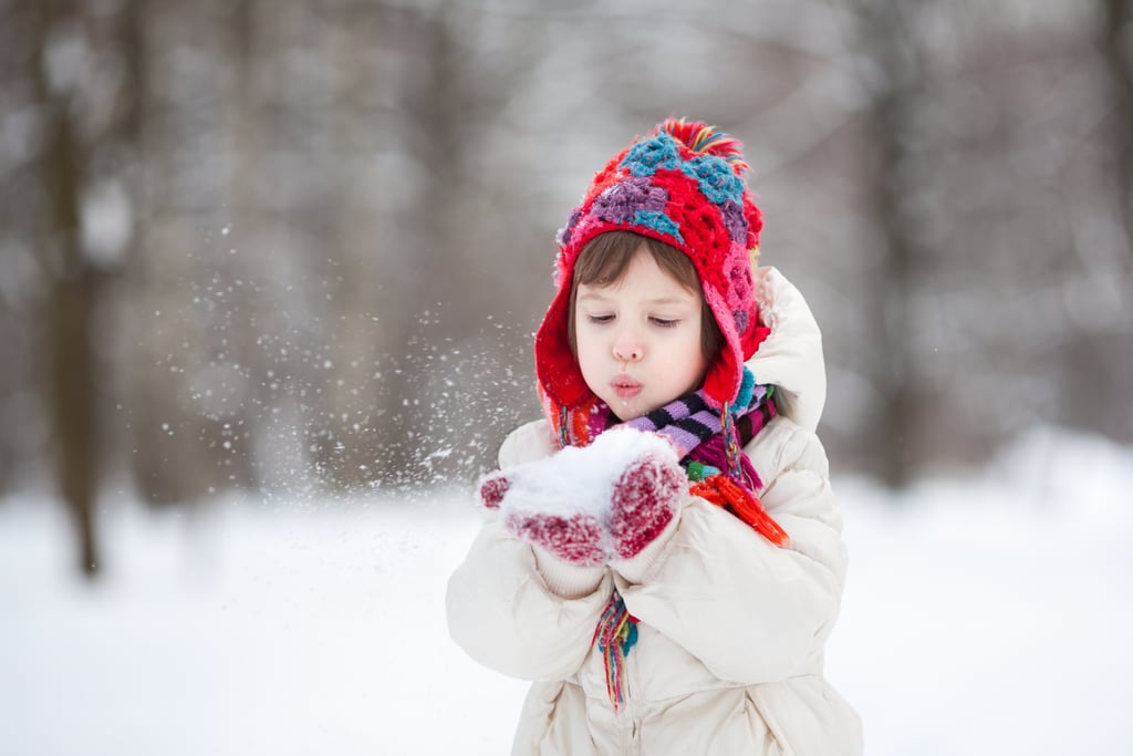 Photo of child blowing snow.