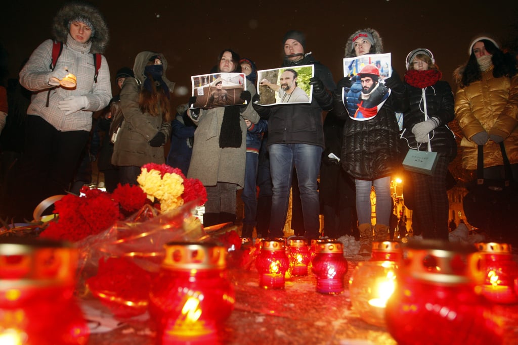 People held portraits of fallen protesters during a candlelight vigil.