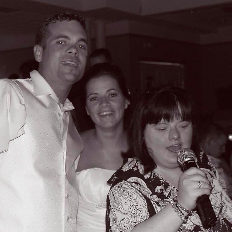 Willson, on her wedding day, with her husband and sister, Dina.