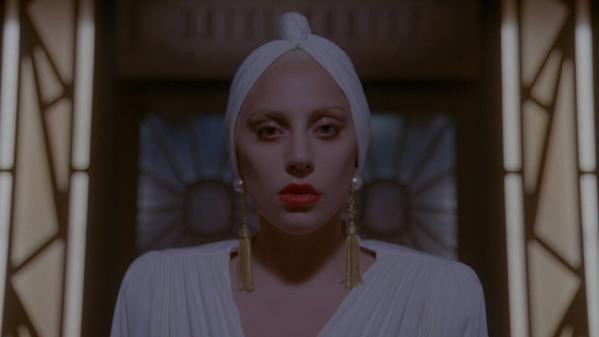 We can't decide what's chicer; the turban or pearl and tassel earrings.