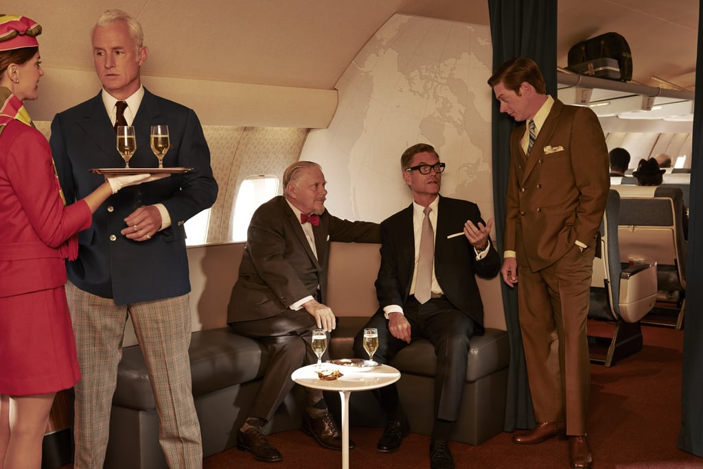 Roger chats up a flight attendant while Bert Cooper (Robert Morse), Jim Cutler (Harry Hamlin), and Ted (Rahm) talk.