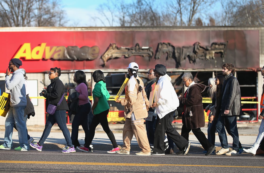 A crowd of NAACP members passed a damaged store.