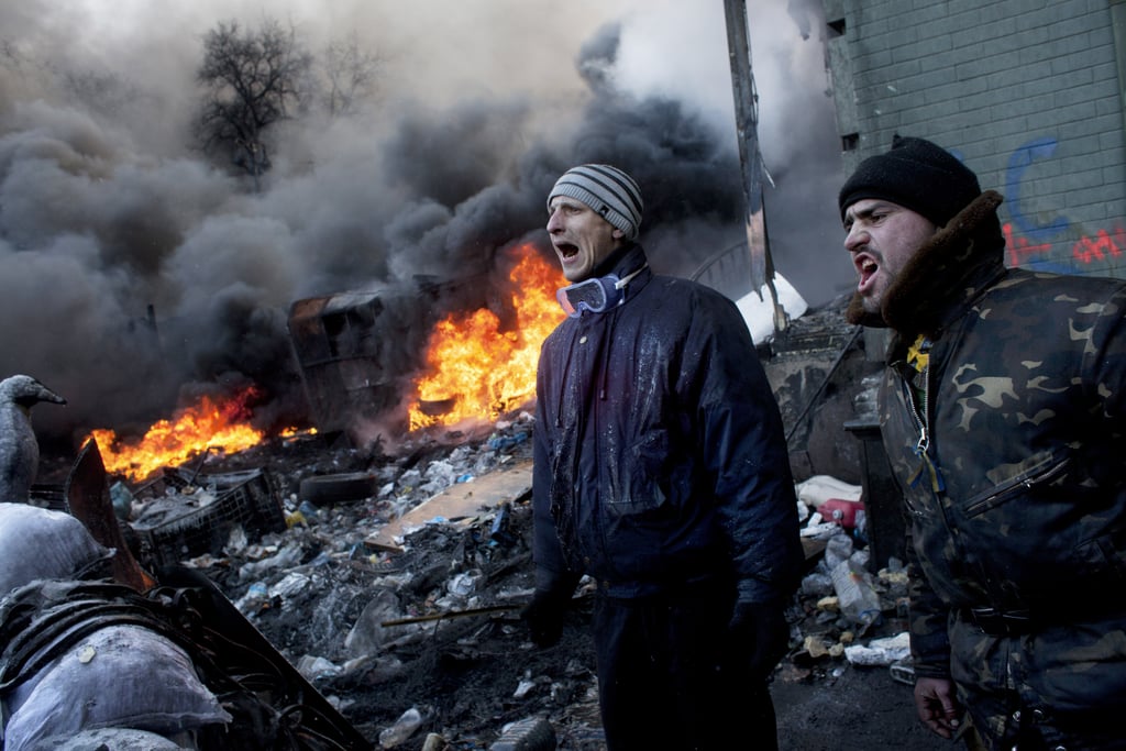 As fires burned, protesters shouted from behind their barricade.