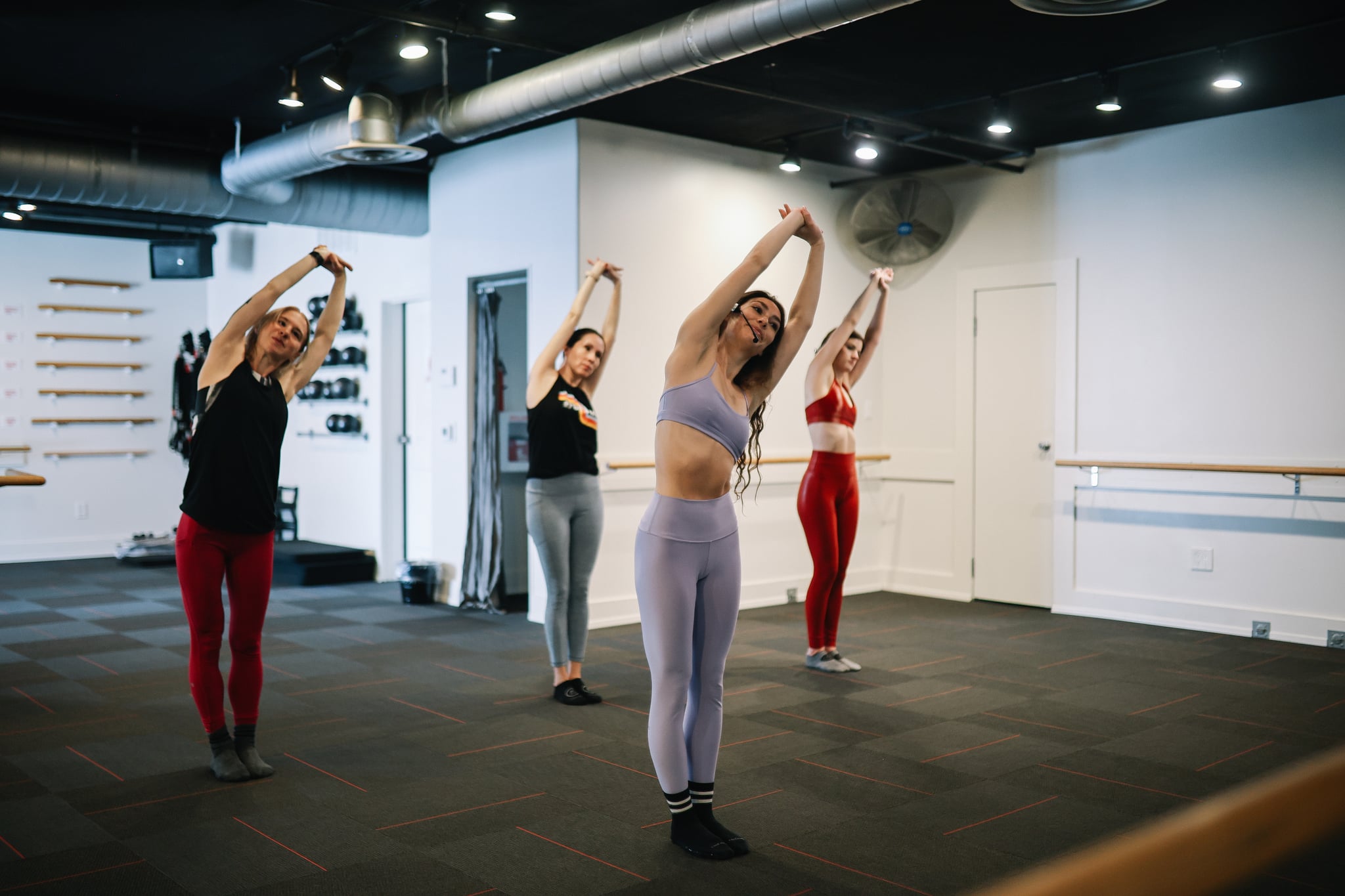 Group of women exercising at a barre class in a gym in Santa Monica, Los Angeles.