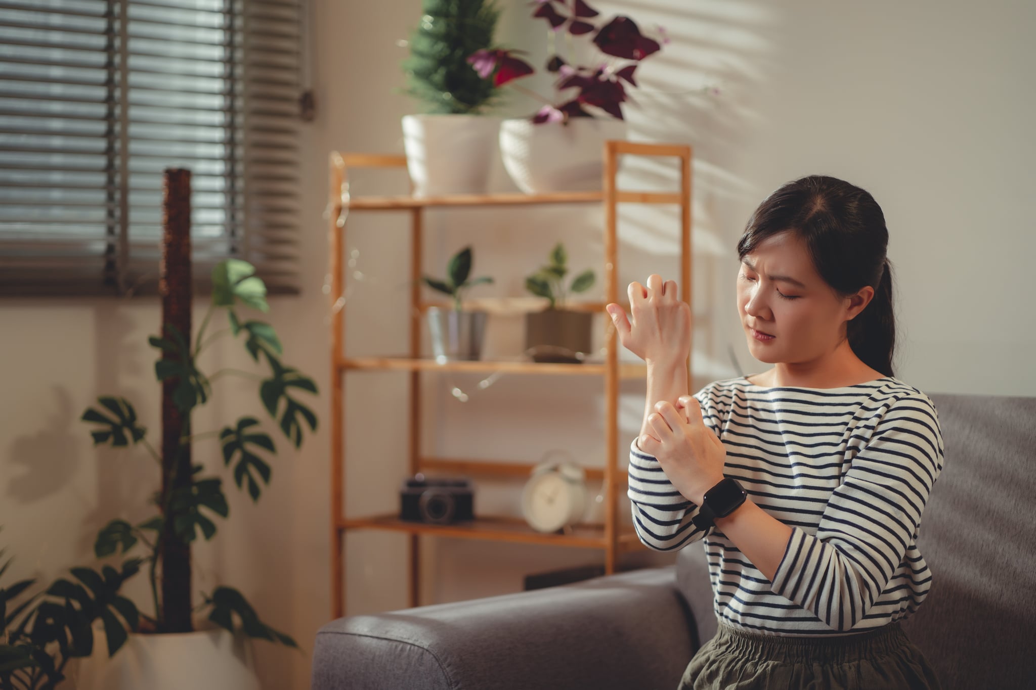 Woman scratching her arm, looking for natural mosquito bite remedies