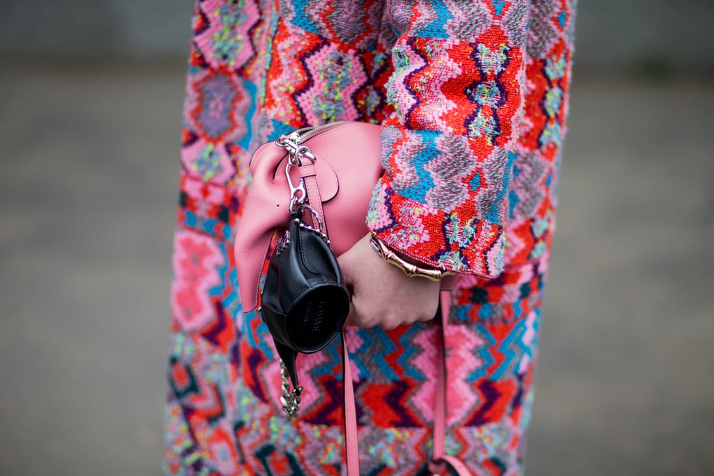 Clasp a playful pouch onto your larger bag, just like this Loewe pairing.