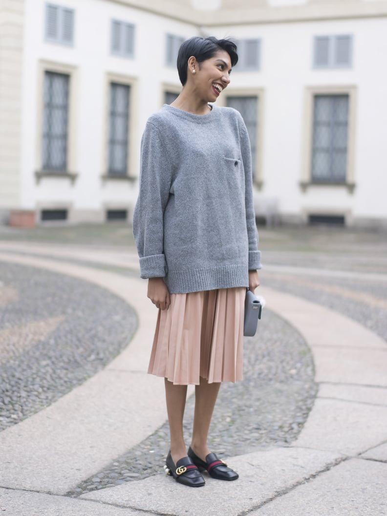 A sweater, a skirt, and flats