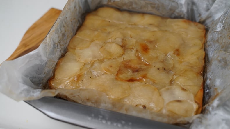 15-hour potatoes recipe: sliced potatoes setting in a pan