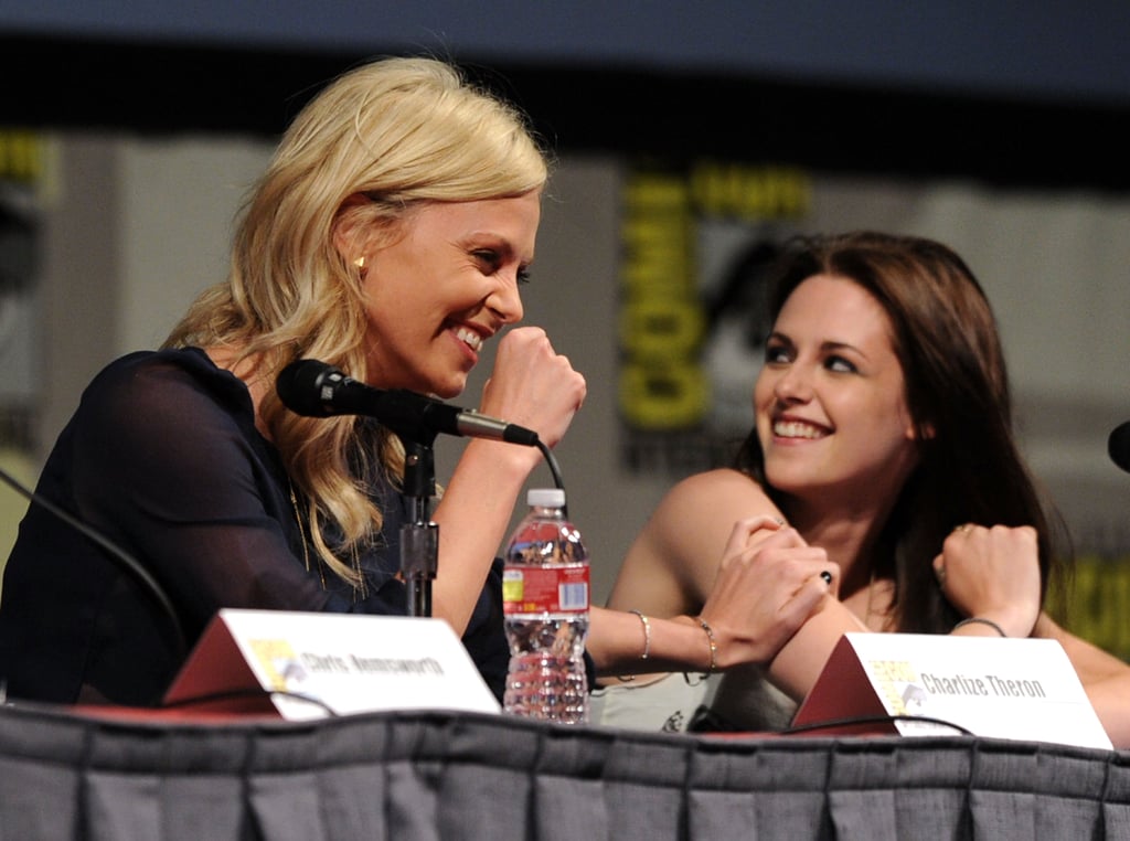 Charlize Theron and Kristen Stewart shared a laugh during the Snow White and the Huntsman panel discussion in 2011.