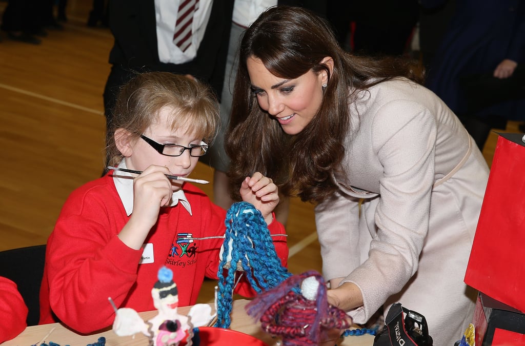 Kate Middleton checked out a little girl's art project during a November 2012 visit to the Manor School in Cambridge, England.