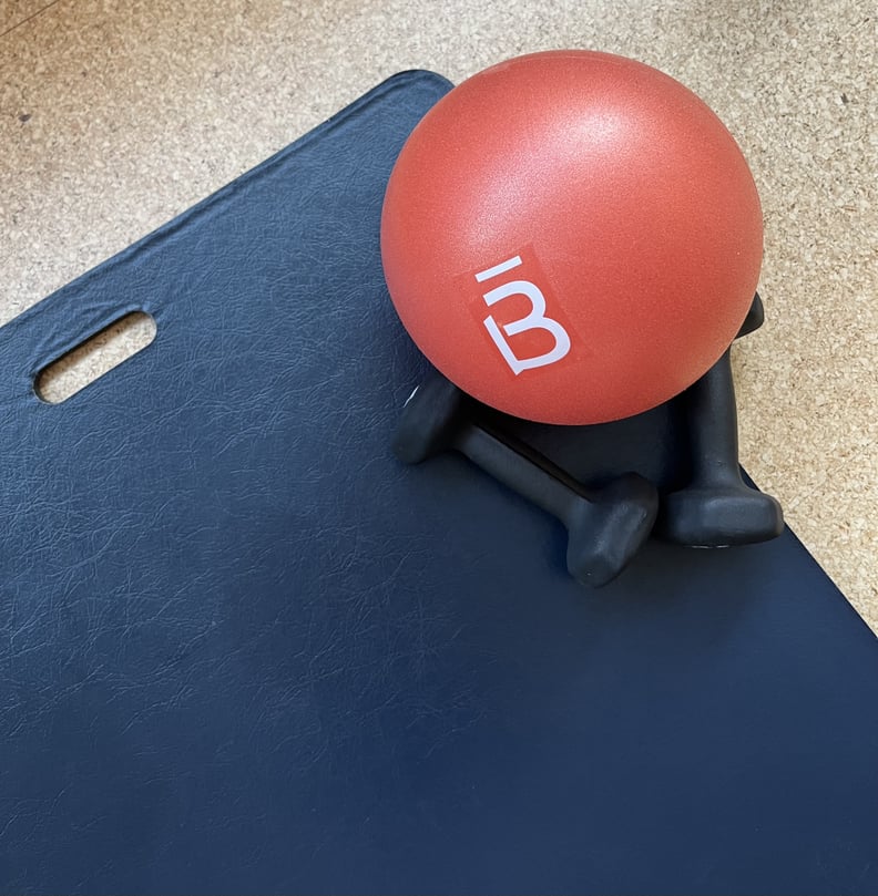 Barre Ball with Weights on a Black Yoga Mat