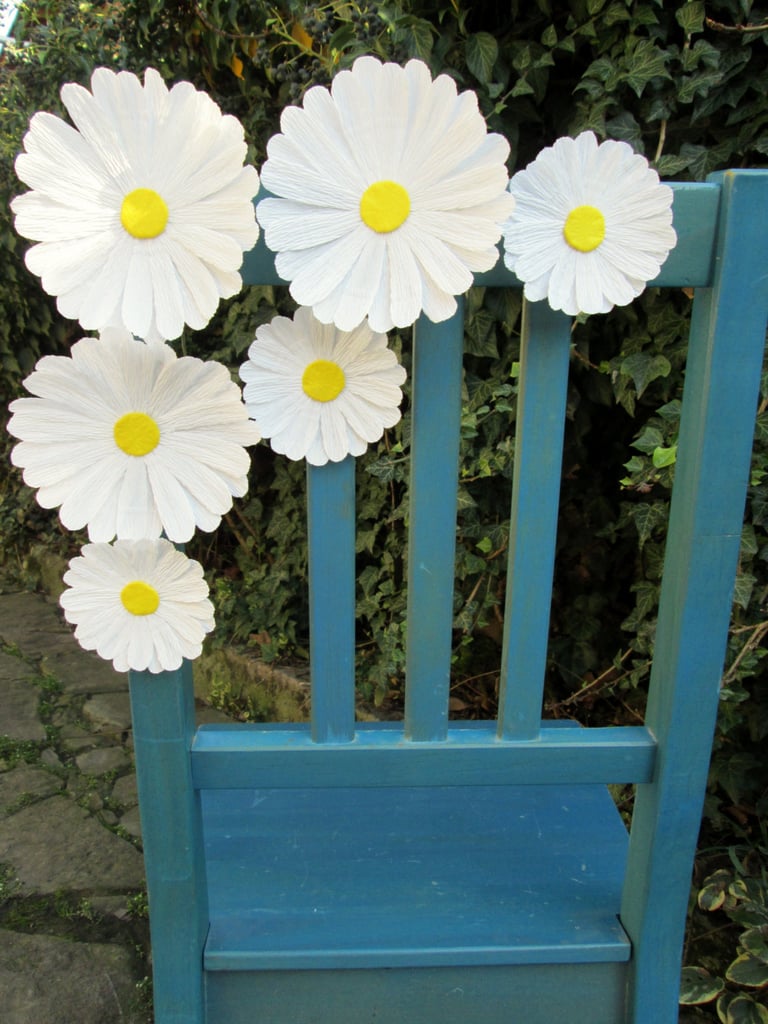 Delicate daisies were the flower du jour in the 90s, and they're the perfect theme for accent pieces, like  wedding chair flowers ($12).