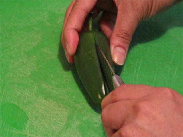 Step 1: Slice through half the chile lengthwise. Step 1: Slice through half the chile lengthwise.