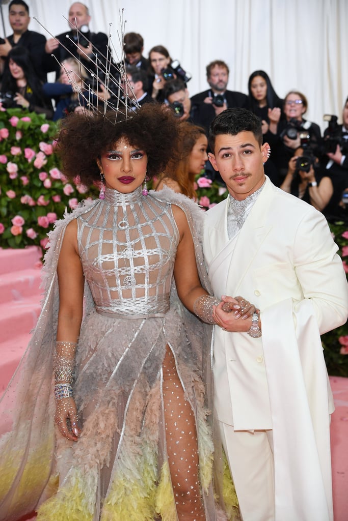 Nick Jonas and Priyanka Chopra arrived to the Met Gala in New York City on Monday night looking like a true power couple. While Nick rocked a suave all-white ensemble, Priyanka really embraced the theme, "Camp: Notes on Fashion," with a silver gown and feathery cape. To top off the look, she rocked a tall crown fit for a queen.Their appearance came less than a week after Nick performed at the Billboard Music Awards with his brothers. And, of course he performed one of the Jonas Brothers' latest singles, "Sucker" — which Priyanka probably enjoyed, considering her special feature in the song's music video. Between their red carpet appearances and adorable social media moments, they sure know how to make us swoon!