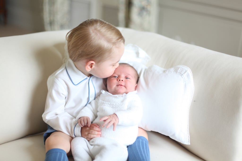 George gave Charlotte a kiss during the baby's first official photo shoot in May 2015.