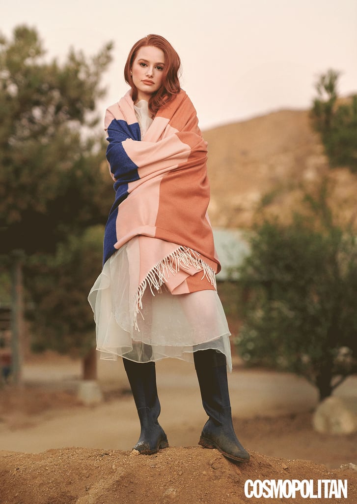 Wearing a Sandy Liang sheer dress, a Sandy Liang pink bralette, Calle Del Mar Knit Bottoms in peony, Le Chameau rain boots, Jia Jia earrings, a Jia Jia ring, and a Viso Project mohair and wool multicolored blanket.