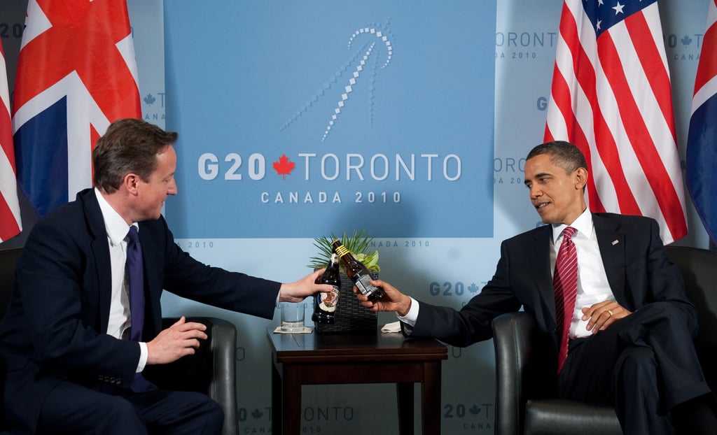 The leaders of the US and UK traded bottles of beers to settle a bet on the US-UK soccer game during the 2010 World Cup.