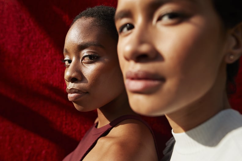 Close-up of friends against red wall