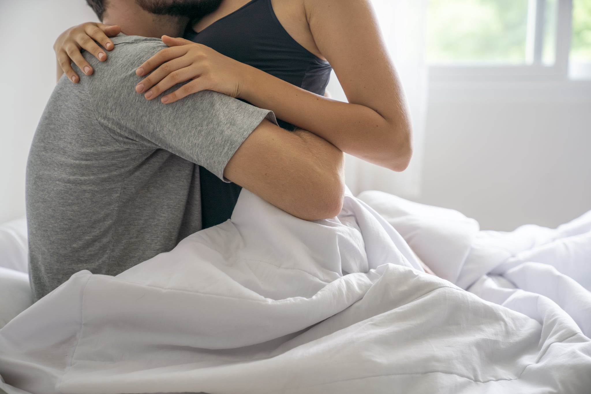 couple doing a lazy sex position in bed