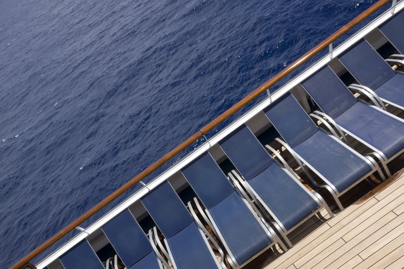 a row of empty chairs on the deck of a cruise ship