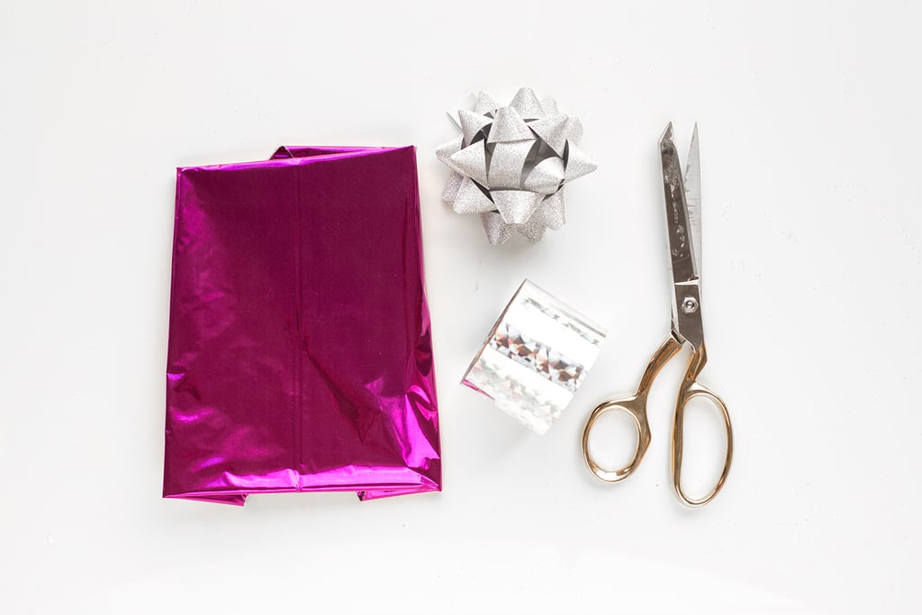 To Make:
1. Inflate the cube balloons with helium and tie with ribbon. Mylar balloons will float for up to four days, so you can even do this the day or two before your party!
2. Use a glue dot to adhere the end of your Mylar streamer to the bottom of one side of the balloon, right next to the tail. Pull that streamer all the way around the balloon, over the top, and to the other side. Trim to the correct length and use another glue dot to adhere to the bottom of the balloon again.
