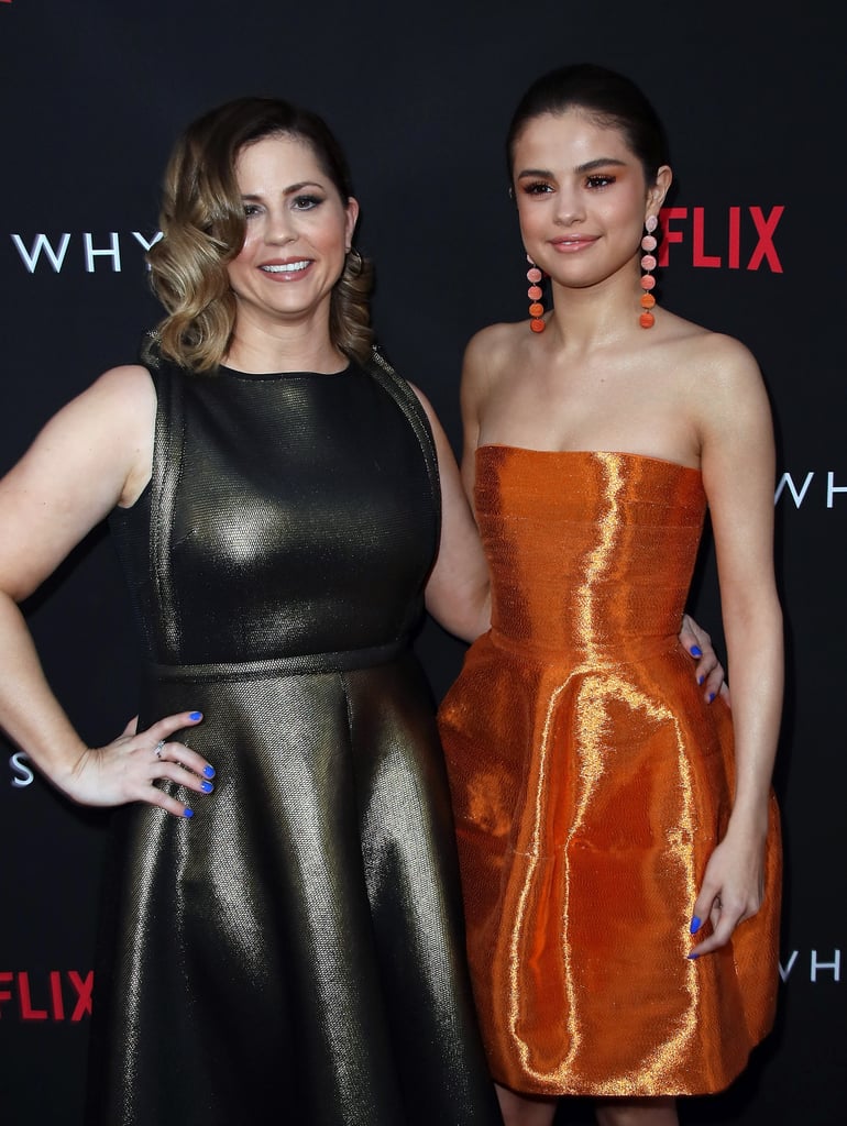 Without Selena Gomez and her mom, Mandy Teefey, Netflix's 13 Reasons Why would not exist. The unstoppable mother-daughter pair celebrated their roles as executive producers on the teen drama at the show's LA premiere on Thursday, where they hit the red carpet in style. Selena rocked a gorgeous, glowing orange gown, while her mom stuck with classic black, and both sported a matching shade of bright blue nail polish. Cute, right? The "Only You" singer then posed for photos with lead actors Dylan Minnette and Katherine Langford before giggling in a group photo with the rest of the cast. We can't wait to see where the globetrotting pop star shows up next!