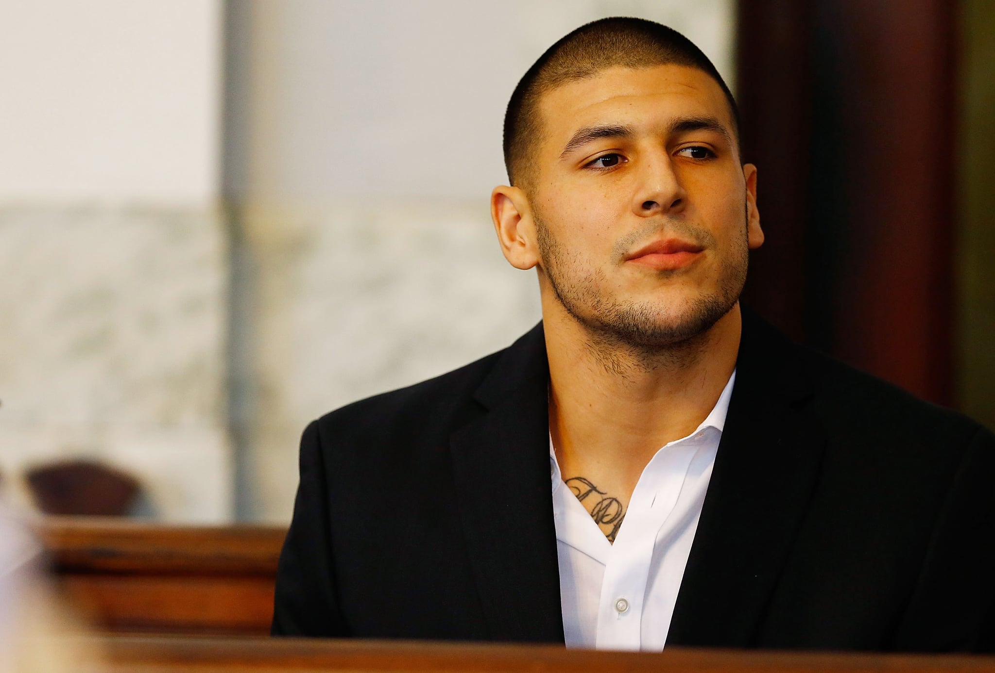 NORTH ATTLEBORO, MA - AUGUST 22: Aaron Hernandez sits in the courtroom of the Attleboro District Court during his hearing on August 22, 2013 in North Attleboro, Massachusetts. Former New England Patriot Aaron Hernandez has been indicted on a first-degree murder charge for the death of Odin Lloyd. (Photo by Jared Wickerham/Getty Images)