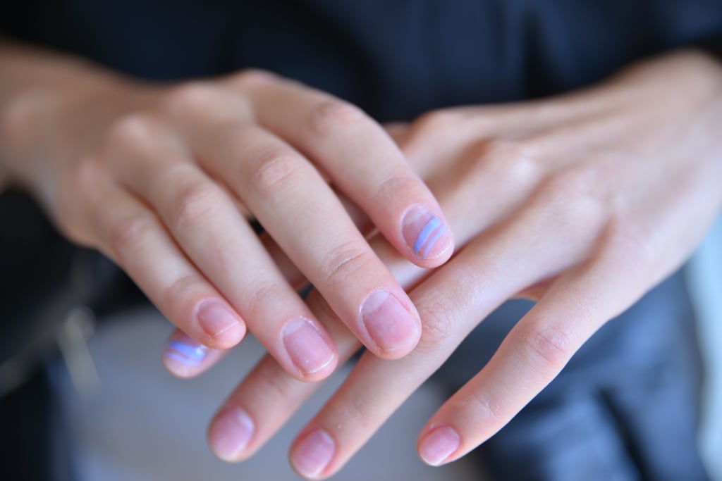 Here you can see the purple nail polish via stripes painted onto models' index fingers.