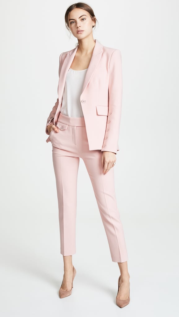 Premium Photo  Elegant woman in pretty pastel pale pink suit, jacket,  trousers, sunglasses on white background