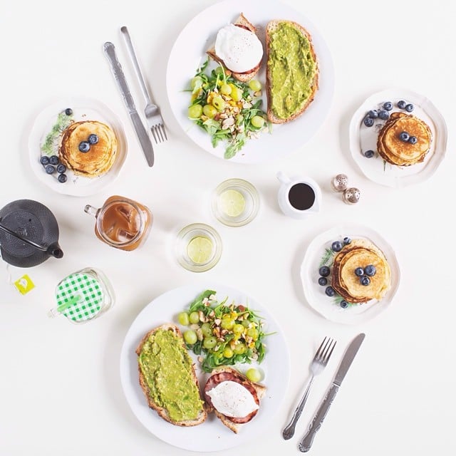 Here's a brunch table we would love to sit at: avocado toast, poached egg and bacon toast, blueberry pancakes, and a salad of arugula, grapes, and almonds.
Source: Instagram user paulinefashionblog