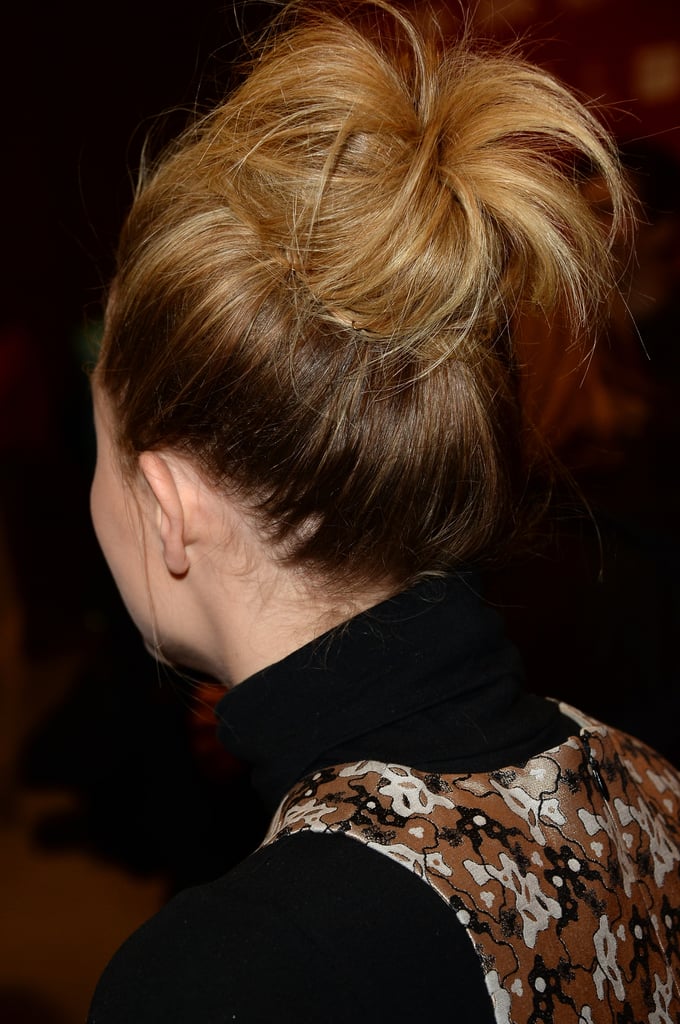 "For Chloë's look for the premiere, we wanted to do a textured, fashion-inspired topknot," said Urban. "I began by spraying her damp hair section by section with Leonor Greyl's Voluforme ($36) for volume and lift and then blew it dry with a large round brush. In one-inch sections, I backcombed all of her hair loosely and then gathered it into a high ponytail with my hands and secured with an elastic. I didn't want to brush the ponytail into place, because then I would lose the texture from the backcombing. I teased the pony, wrapped it into a bun, and secured with bobby pins and hair pins."
And the most important part? "I pulled the bun apart slightly and pulled out some wispy pieces around the hairline to give it a really loose, textured feel," the beauty pro explained. "To finish and set the look, I sprayed Chloë's hair with Leonor Greyl Spray Structure Naturelle ($38) for all-night hold."
Hear that girls? So put down your bun roller and use the texture that you've got to create a mega bun. Second-day hair encouraged.