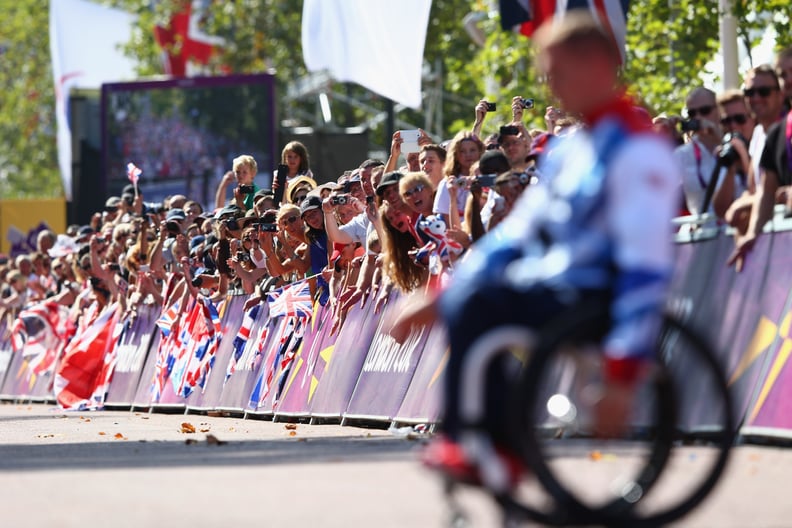 LONDON, ENGLAND - SEPTEMBER 09:  David Weir of Great Britain is cheered by the crowds as he makes his way to the winners podium on The Mall after his fourth gold medal of the Paralympic Games after victory in the Men's T54 Marathon on day 11 of the London