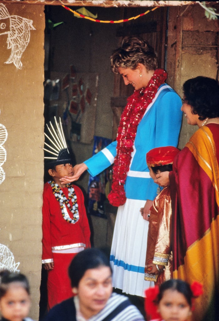 Diana greeted a child at the Tamana Special Needs Nursery School in Delhi, India, in February 1992.