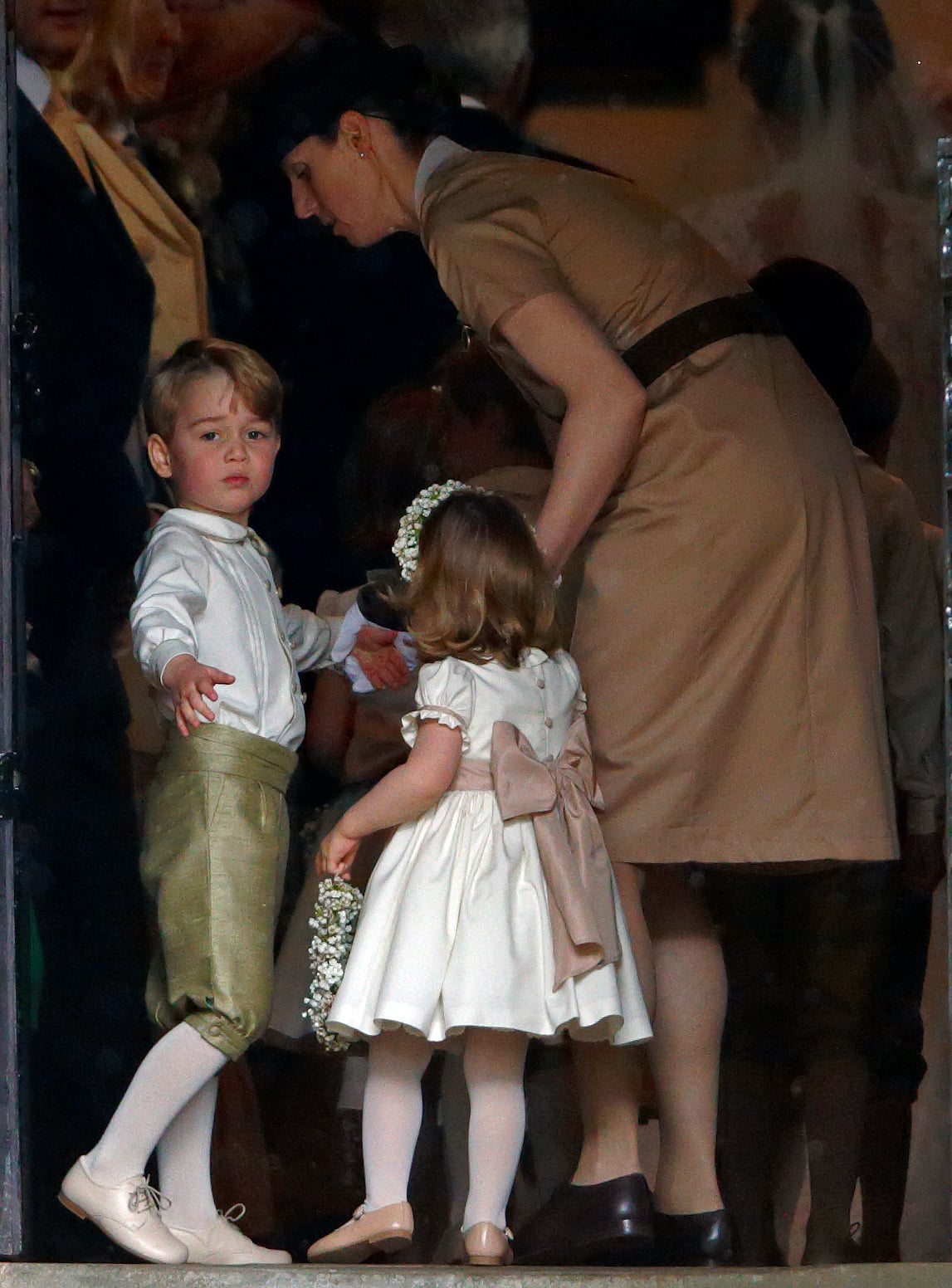 ENGLEFIELD GREEN, UNITED KINGDOM - MAY 20: (EMBARGOED FOR PUBLICATION IN UK NEWSPAPERS UNTIL 48 HOURS AFTER CREATE DATE AND TIME) Prince George of Cambridge and Princess Charlotte of Cambridge accompanied by their nanny Maria Teresa Borrallo attend the wedding of Pippa Middleton and James Matthews at St Mark's Church on May 20, 2017 in Englefield Green, England. (Photo by Max Mumby/Indigo/Getty Images)