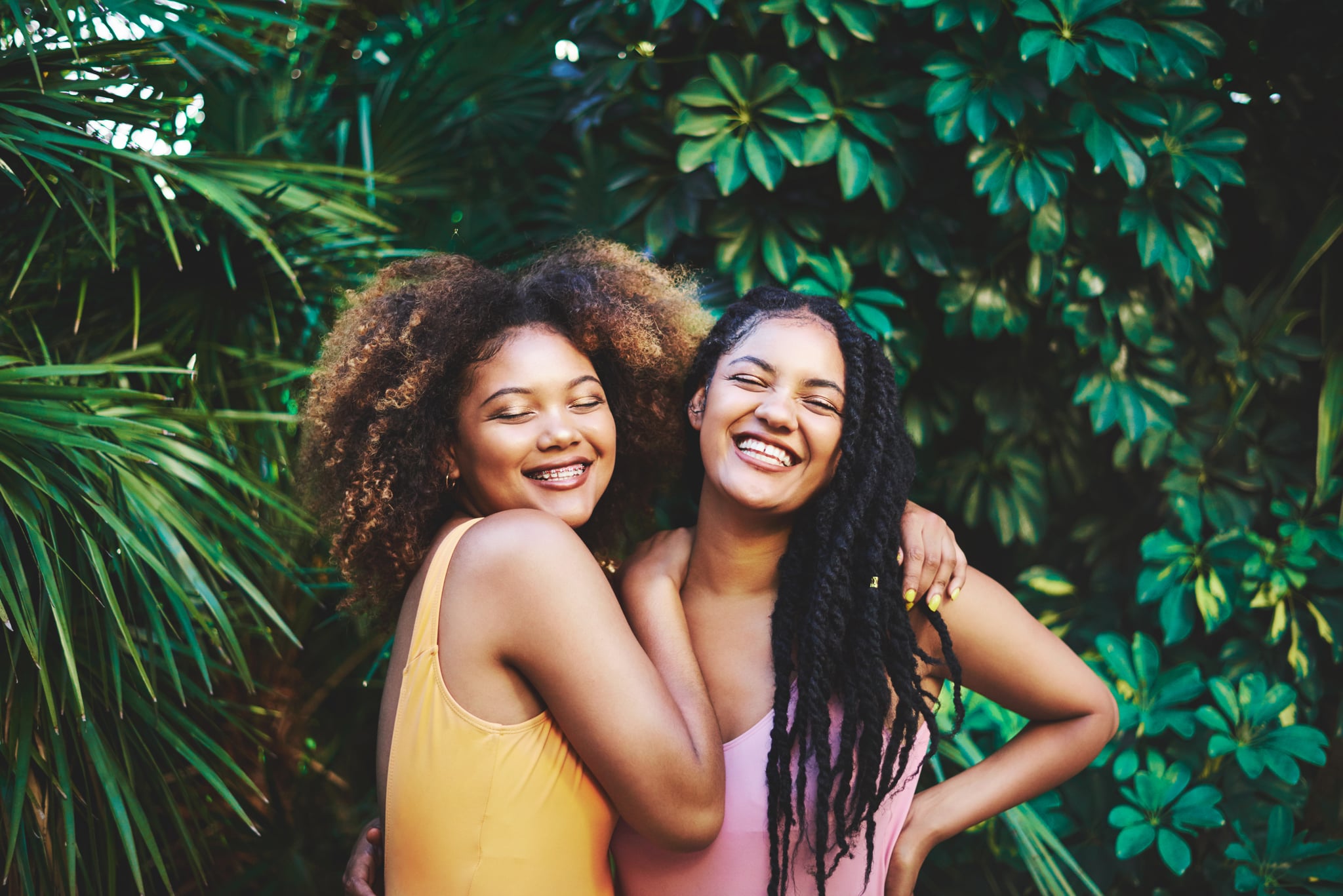 Cropped shot of two beautiful young women posing in nature