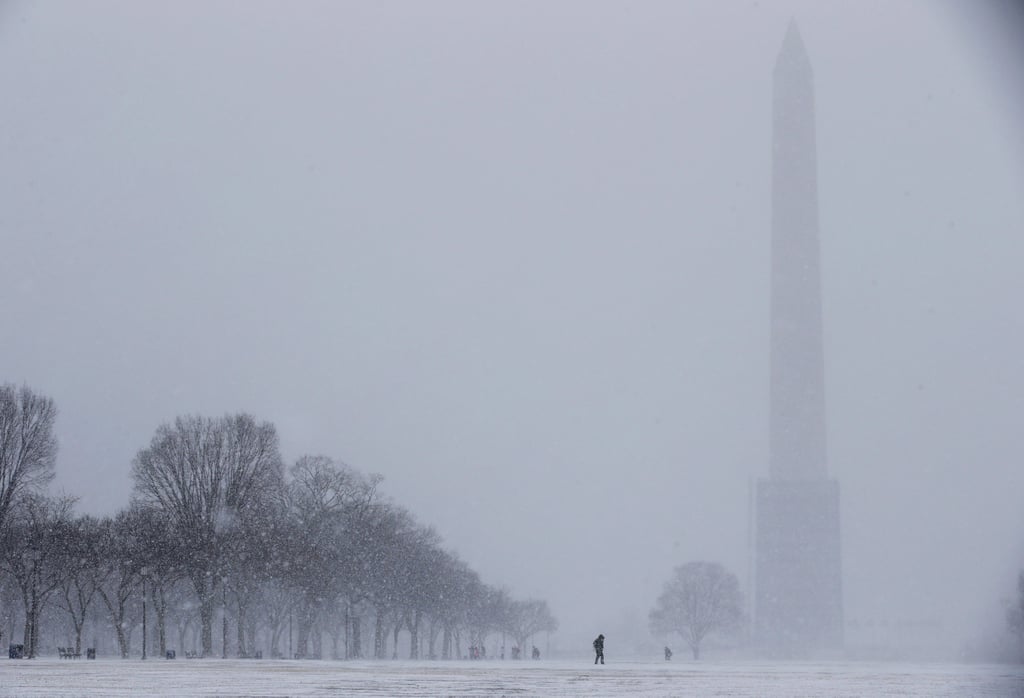 The Washington Monument was barely visible with snow blowing through Washington DC.