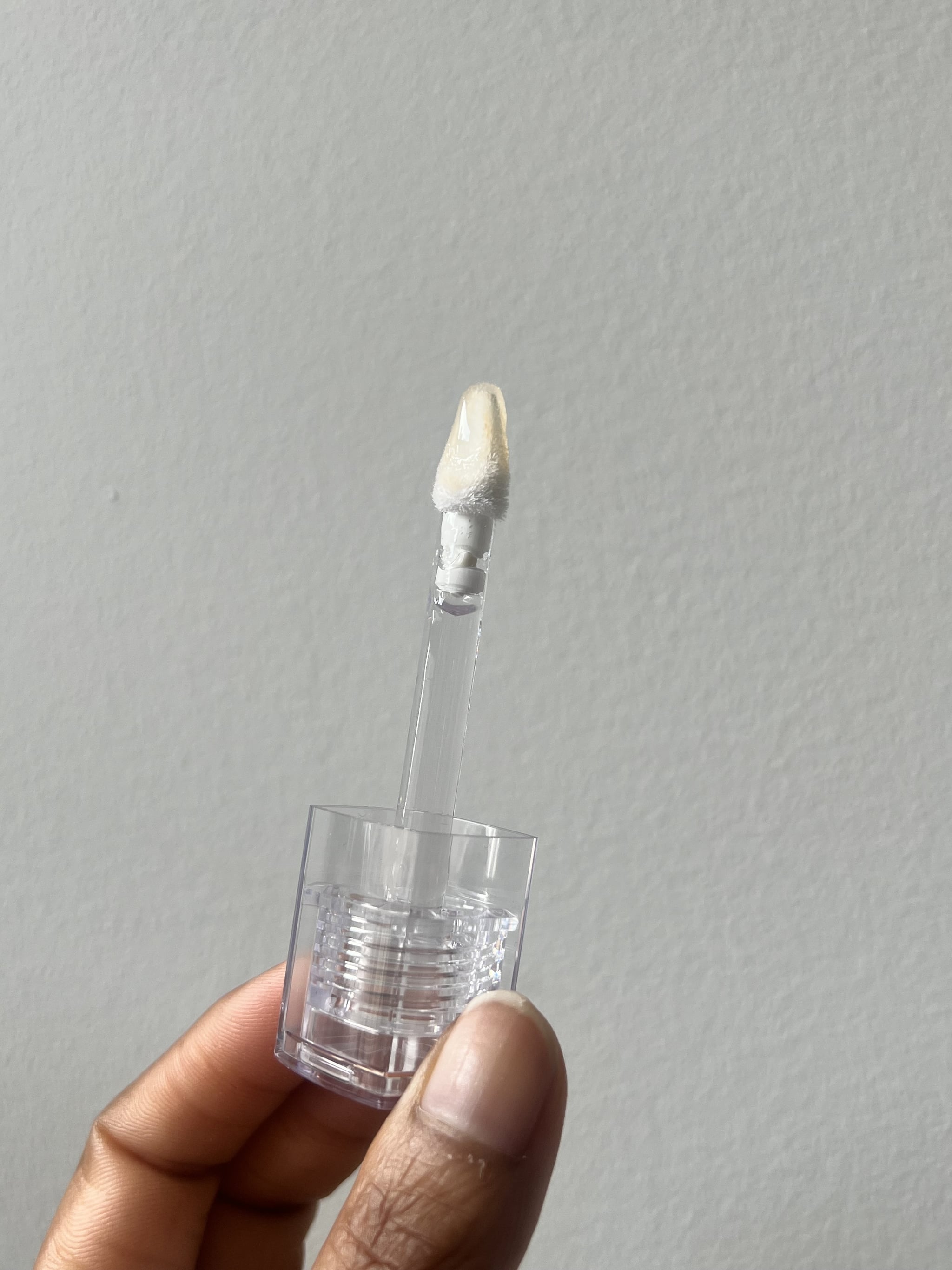 Huda Beauty Faux Filler Extra Shine Lip Gloss doe foot applicator.