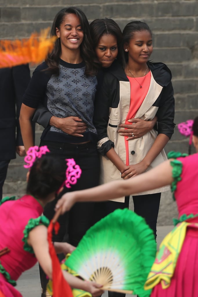 Michelle hugged Malia and Sasha while visiting the Xi'an City Wall in China in March.