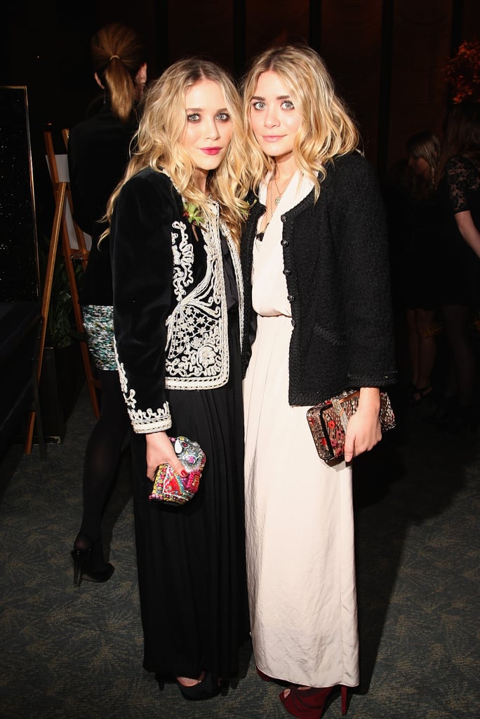 Twinning combo: At the 2009 CFDA new members reception, the darling duo polished their gorgeous gowns with ornate jackets.

Mary-Kate topped her black gown with a velour brocade jacket and colorful miniclutch.
Ashley contrasted her cream-colored crepe gown with a black tweed jacket and burgundy platforms.