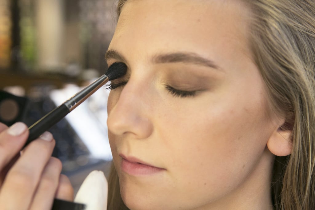 Next, she used a shimmering soft brown eye shadow that she blended all over the eyelid, stopping at the crease.