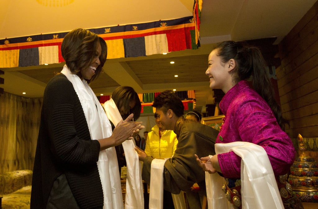 The first lady received a Tibetan scarf when she and her daughters were greeted at the restaurant.