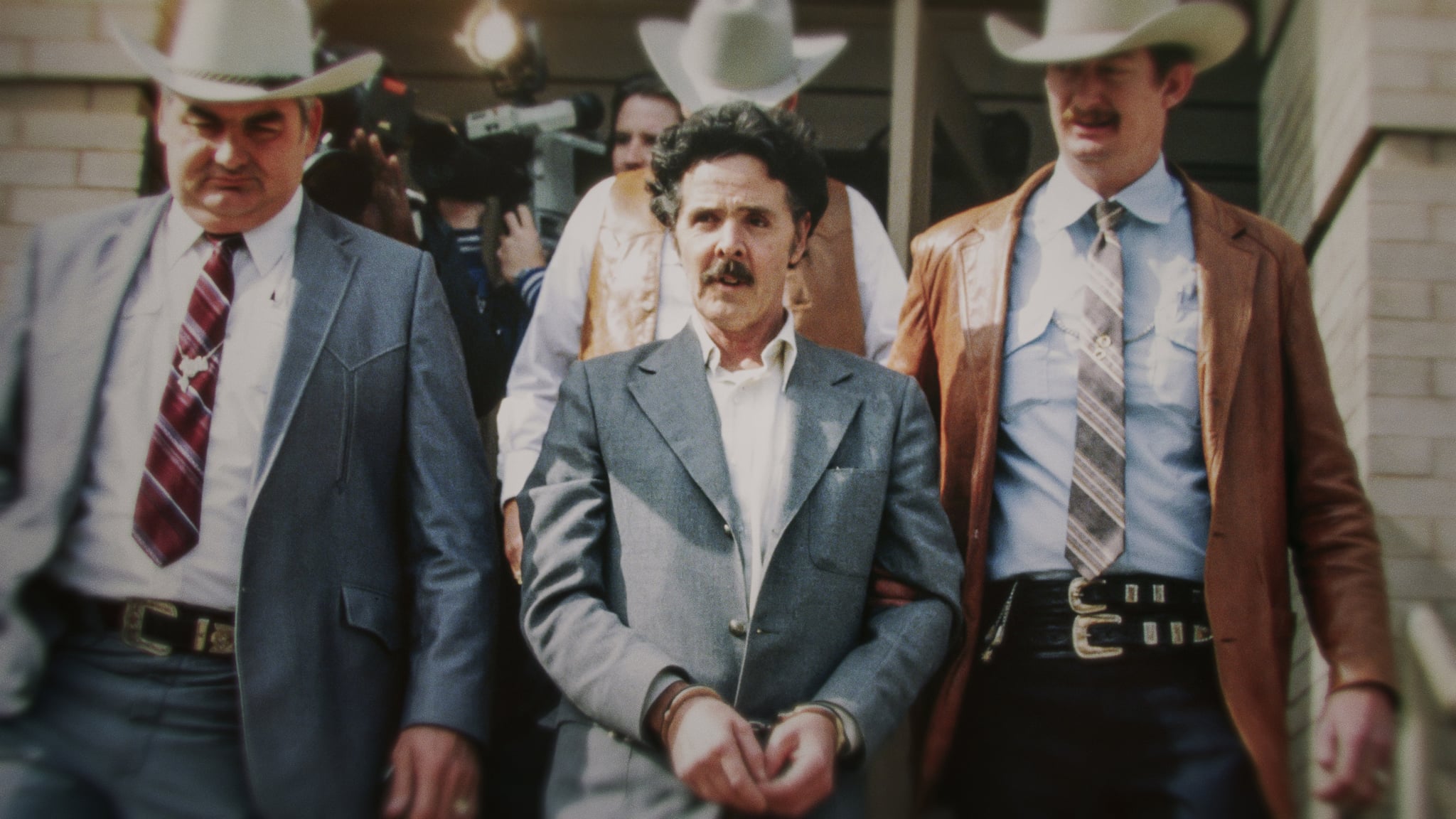 The Confession Killer — Henry Lee Lucas (center) being escorted by Ranger Bob Prince (left) and task force