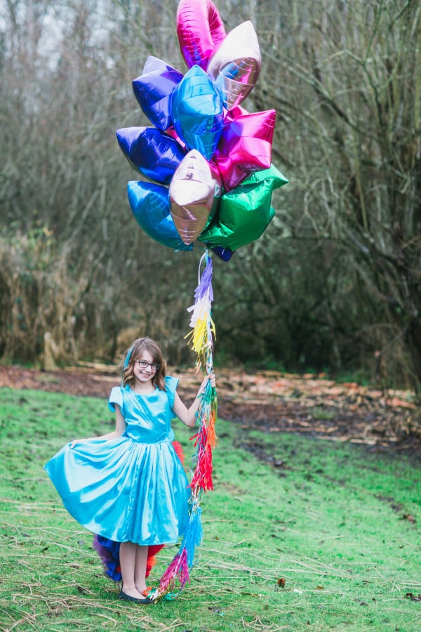 To spice up the huge balloon bundles, I added rainbow tassel garland from PaperWhite Designs to the balloon strings.  They gave the balloons an extra pop of color and texture! Plus these are the cutest photo props! Grab your camera, the guest of honor, a bundle of balloons and you have a darling photo! (Take it a step further by turning the photo into a card and use as a Thank You!)