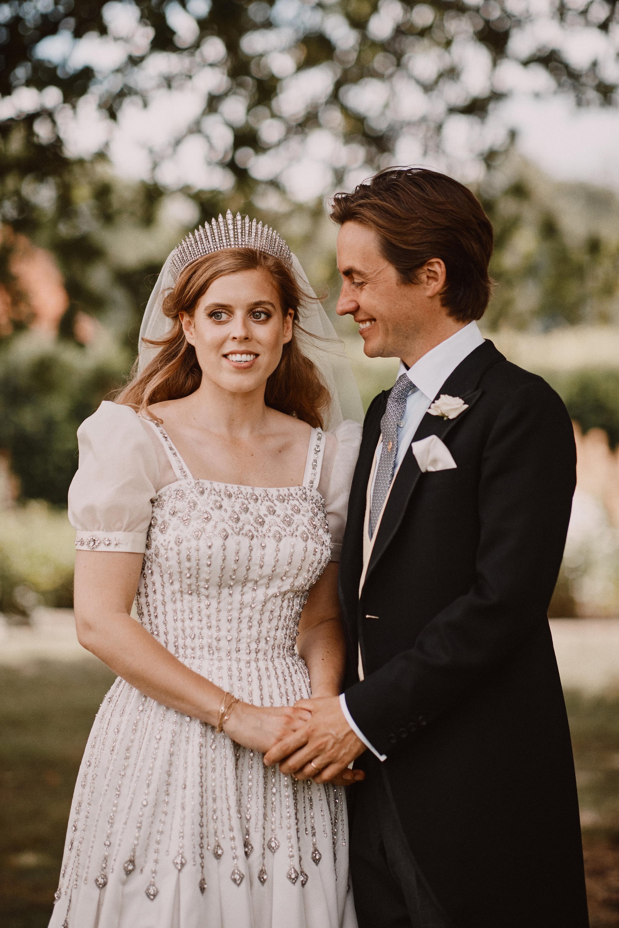 WINDSOR, UNITED KINGDOM - JULY 18: NEWS EDITORIAL USE ONLY. NO COMMERCIAL USE. NO MERCHANDISING, ADVERTISING, SOUVENIRS, MEMORABILIA or COLOURABLY SIMILAR. NOT FOR USE AFTER 18th January 2021 WITHOUT PRIOR PERMISSION FROM BUCKINGHAM PALACE. NO CROPPING. In this handout image released by the Royal Communications, Princess Beatrice and Edoardo Mapelli Mozzi are photographed after their wedding in the grounds of Royal Lodge on July 18, 2020 in Windsor, United Kingdom. (Photo by Benjamin Wheeler via Getty Images) Copyright in the photograph is vested in Princess Beatrice and Edoardo Mapelli Mozzi and Benjamin Wheeler. Publications are asked to credit the photograph to Benjamin Wheeler. No charge should be made for the supply, release or publication of the photograph. The photograph must not be digitally enhanced, manipulated or modified in any manner or form and must include all of the individuals in the photograph when published. NOTE TO EDITORS: This handout photo may only be used in for editorial reporting purposes for the contemporaneous illustration of events, things or the people in the image or facts mentioned in the caption. Reuse of the picture may require further permission from the copyright holder.