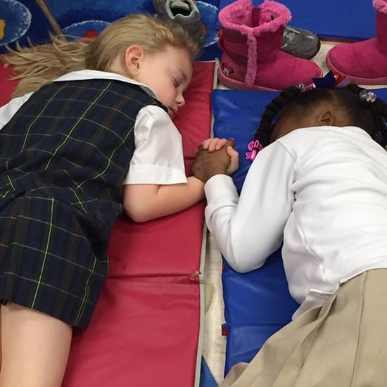 Photo of Two Girls Holding Hands While Napping